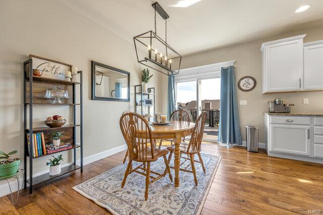 620 Lubbuck Ct, Moscow Mills, MO 63362 - dining space featuring a chandelier, wood finished floors, baseboards, and recessed lighting