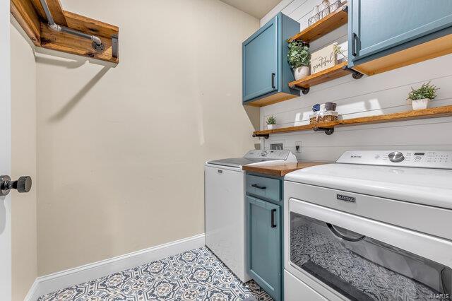 620 Lubbuck Ct, Moscow Mills, MO 63362 - clothes washing area featuring cabinet space, baseboards, and washer and clothes dryer