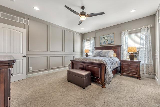 620 Lubbuck Ct, Moscow Mills, MO 63362 - bedroom featuring light carpet, a decorative wall, a ceiling fan, and recessed lighting