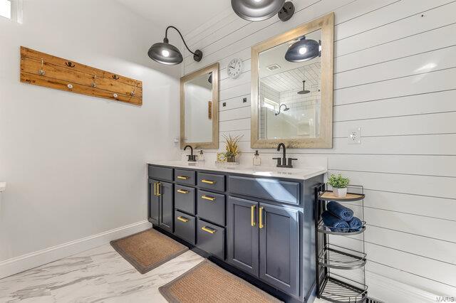 620 Lubbuck Ct, Moscow Mills, MO 63362 - full bath featuring marble look tiles, wood walls, double vanity, and baseboards