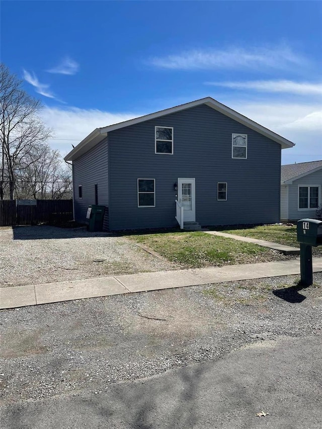 view of side of property featuring fence