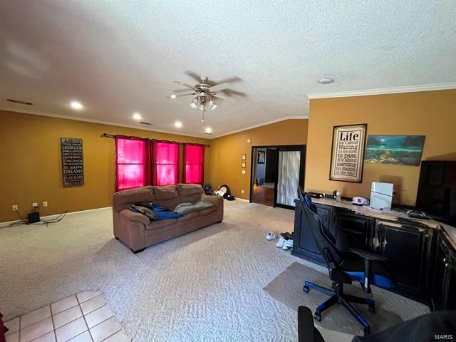 living room featuring an office area, carpet flooring, a ceiling fan, ornamental molding, and lofted ceiling