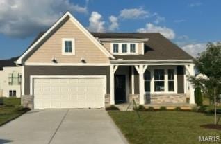 720 Watt Ln, Wentzville, MO 63385 - craftsman inspired home with concrete driveway, a front lawn, an attached garage, and stone siding