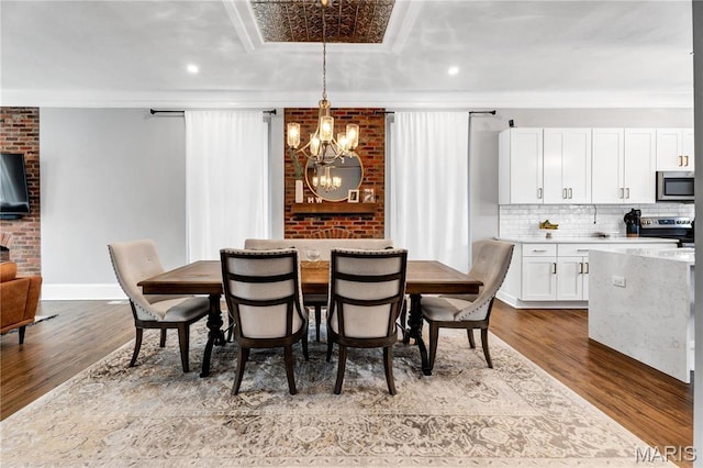4716 Olive St, Saint Louis, MO 63108 - dining area featuring a chandelier, dark wood-type flooring, baseboards, and recessed lighting