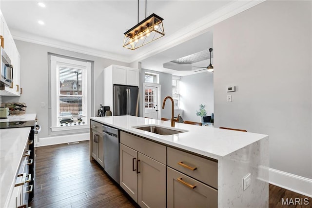 4716 Olive St, Saint Louis, MO 63108 - kitchen with a sink, appliances with stainless steel finishes, baseboards, dark wood-style flooring, and a center island with sink