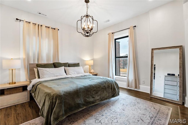 4716 Olive St, Saint Louis, MO 63108 - bedroom with a chandelier, wood finished floors, and baseboards