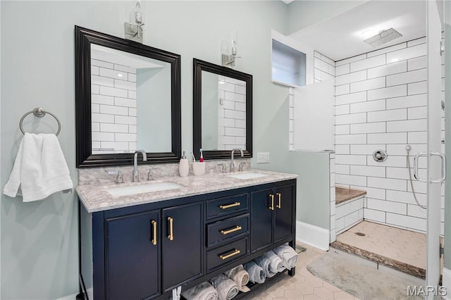 4716 Olive St, Saint Louis, MO 63108 - bathroom featuring a stall shower, double vanity, baseboards, and tile patterned flooring