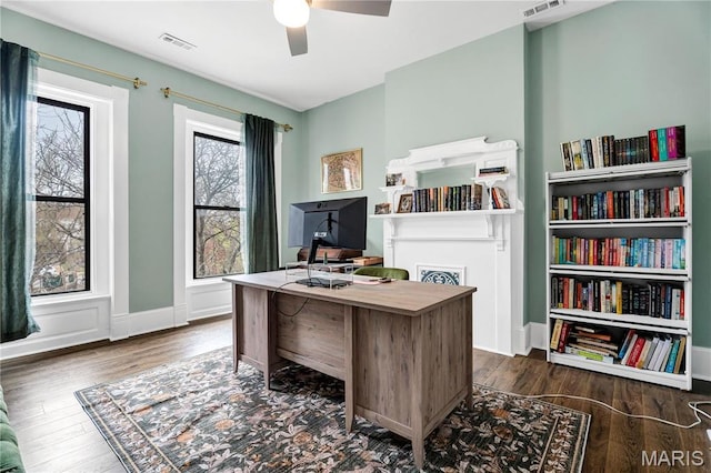 4716 Olive St, Saint Louis, MO 63108 - home office with a ceiling fan and dark wood-style flooring