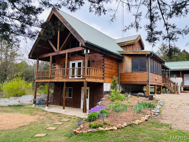 19125 County Road 1220, St James, MO 65559 - back of house with a wooden deck, a sunroom, a patio area, metal roof, and stairs