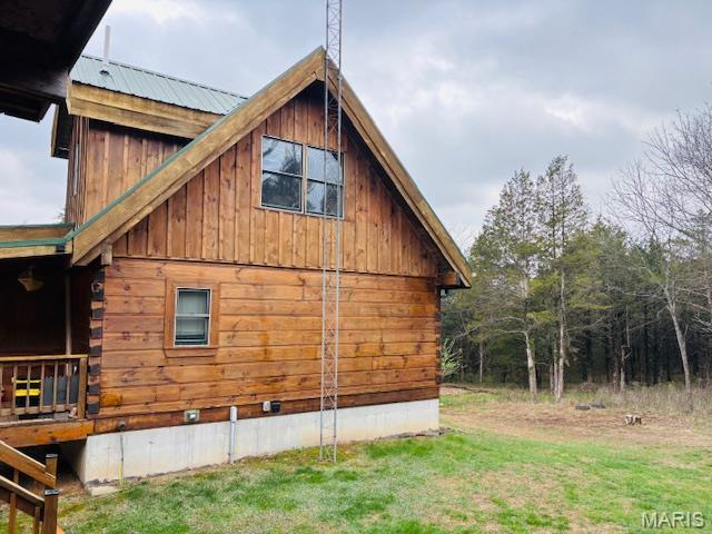 19125 County Road 1220, St James, MO 65559 - view of side of home featuring a lawn and metal roof