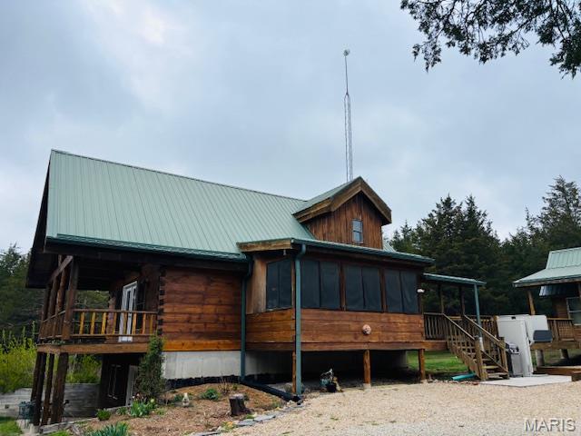 19125 County Road 1220, St James, MO 65559 - view of front facade featuring a sunroom, metal roof, and stairway