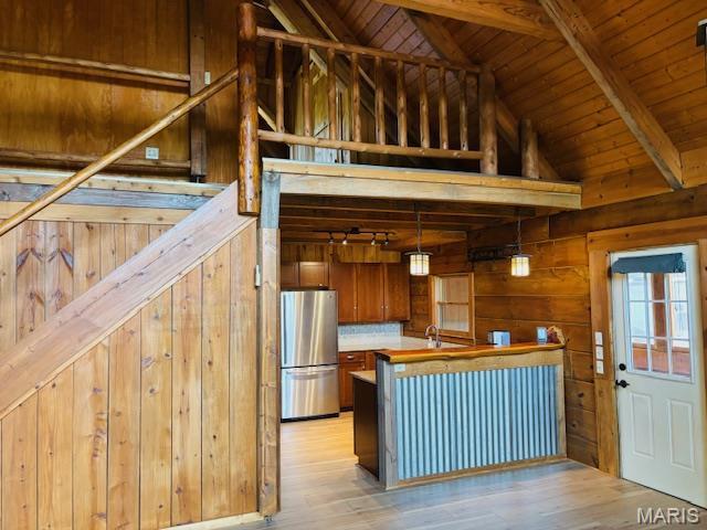 19125 County Road 1220, St James, MO 65559 - kitchen featuring freestanding refrigerator, wood walls, light wood-style flooring, wood ceiling, and hanging light fixtures