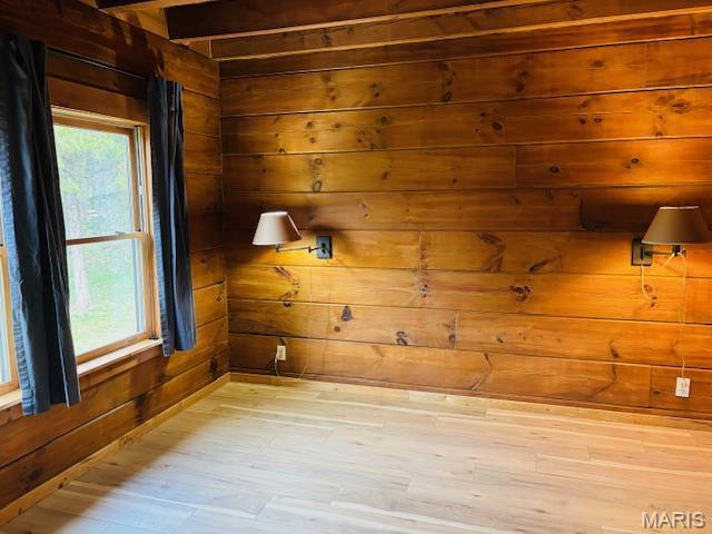 19125 County Road 1220, St James, MO 65559 - empty room with wood walls and light wood-style flooring