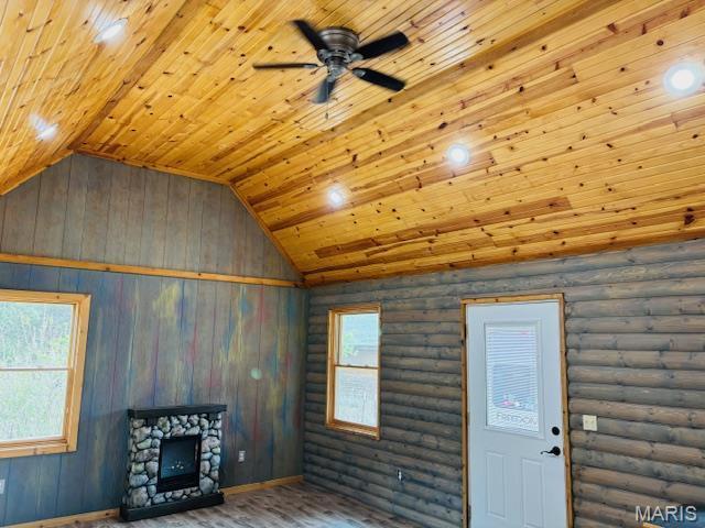 19125 County Road 1220, St James, MO 65559 - unfurnished living room featuring wooden ceiling, a ceiling fan, wood finished floors, vaulted ceiling, and rustic walls