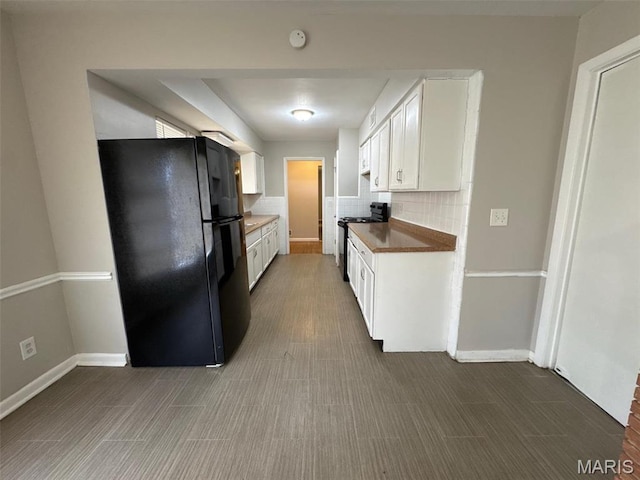 2355 Redman Rd, Saint Louis, MO 63136 - kitchen featuring black appliances, white cabinets, decorative backsplash, and baseboards