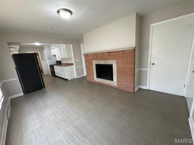 2355 Redman Rd, Saint Louis, MO 63136 - unfurnished living room featuring a fireplace and baseboards