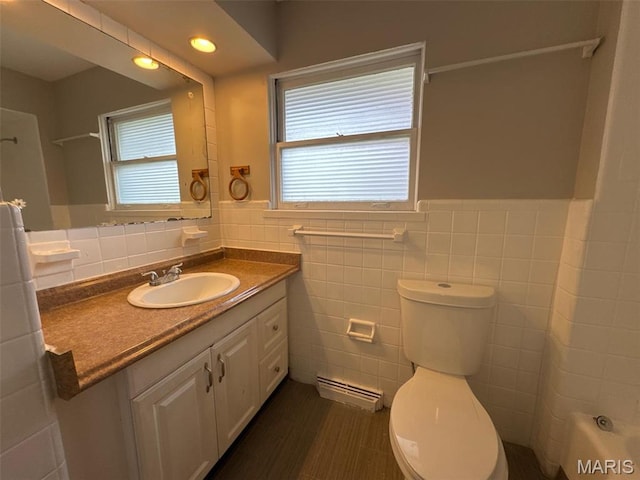 2355 Redman Rd, Saint Louis, MO 63136 - bathroom featuring tile walls, toilet, vanity, wainscoting, and tile patterned flooring