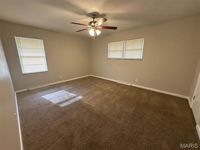 2355 Redman Rd, Saint Louis, MO 63136 - empty room featuring healthy amount of natural light, a ceiling fan, and dark carpet