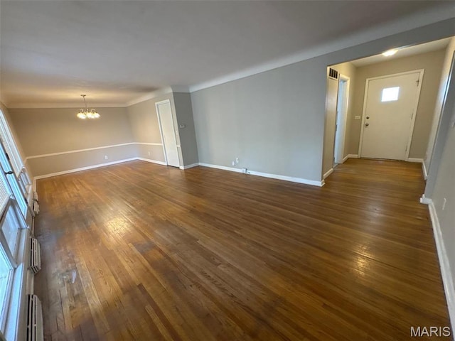 2355 Redman Rd, Saint Louis, MO 63136 - unfurnished living room with a chandelier, dark wood-style flooring, baseboards, crown molding, and a baseboard radiator