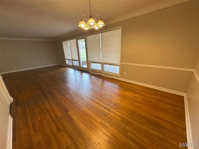 2355 Redman Rd, Saint Louis, MO 63136 - spare room featuring a chandelier, dark wood-style floors, baseboards, and ornamental molding