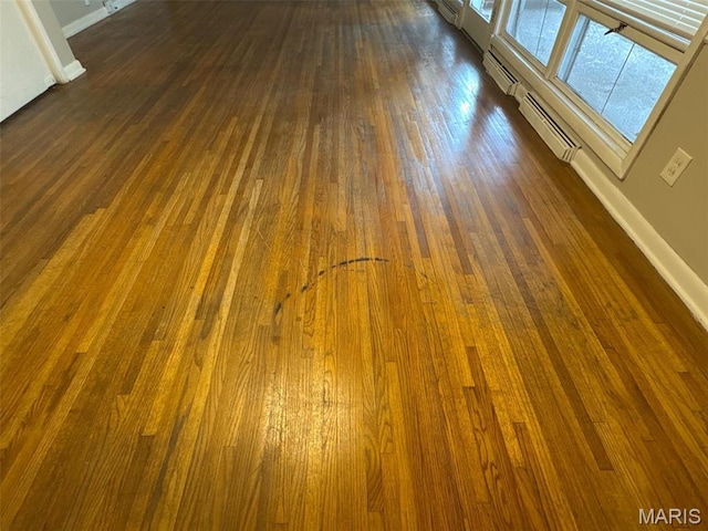 2355 Redman Rd, Saint Louis, MO 63136 - detailed view of baseboards, wood finished floors, and baseboard heating
