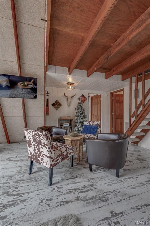 628 W St Gallen Dr, Innsbrook, MO 63390 - living area featuring wooden ceiling, beam ceiling, wood finished floors, and stairs