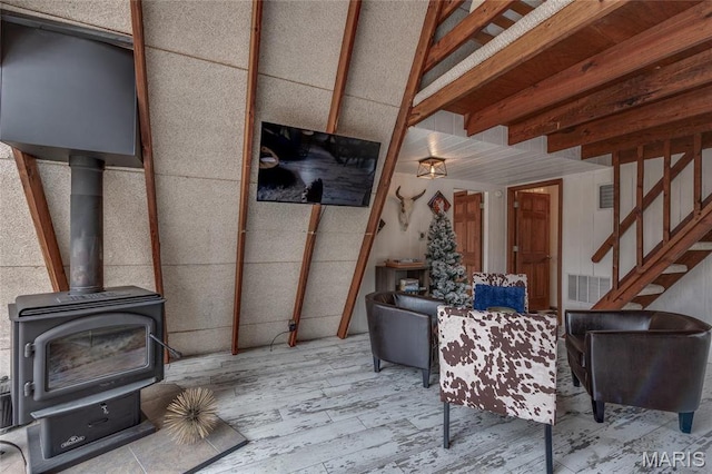 628 W St Gallen Dr, Innsbrook, MO 63390 - living room with wood finished floors, stairway, and a wood stove