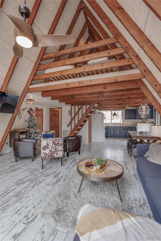 628 W St Gallen Dr, Innsbrook, MO 63390 - living area featuring beamed ceiling, high vaulted ceiling, wood finished floors, and stairway