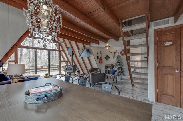 628 W St Gallen Dr, Innsbrook, MO 63390 - dining area with a wood stove, beam ceiling, and wood finished floors