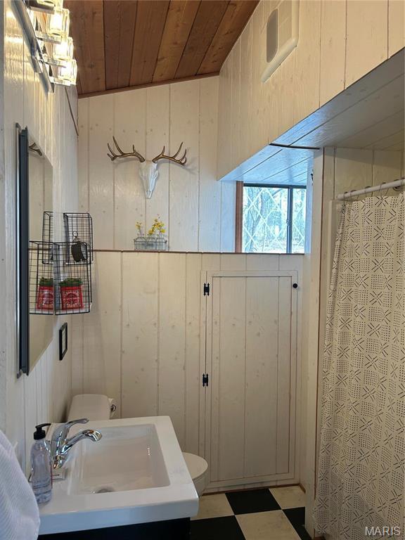 628 W St Gallen Dr, Innsbrook, MO 63390 - full bathroom featuring wood ceiling, wooden walls, vanity, a shower with curtain, and tile patterned floors
