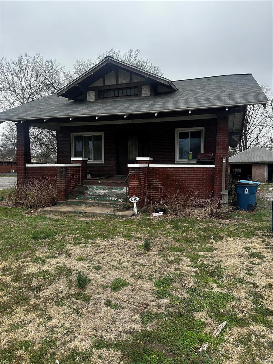 830 N Wood River Ave, Wood River, IL 62095 - back of property with brick siding and covered porch