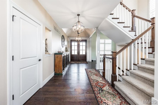 7032 Koufax Ct, Edwardsville, IL 62025 - foyer entrance with a chandelier, dark wood-style floors, stairway, and baseboards