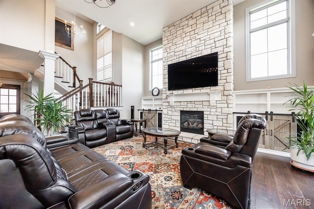 7032 Koufax Ct, Edwardsville, IL 62025 - living area featuring dark wood-style floors, a towering ceiling, a fireplace, and stairs