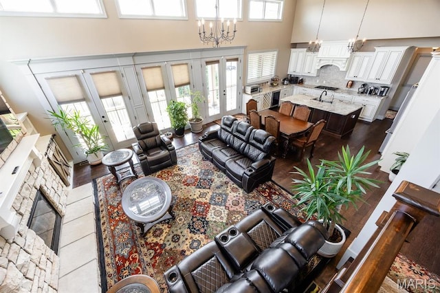 7032 Koufax Ct, Edwardsville, IL 62025 - living area with a towering ceiling, a fireplace, and a chandelier