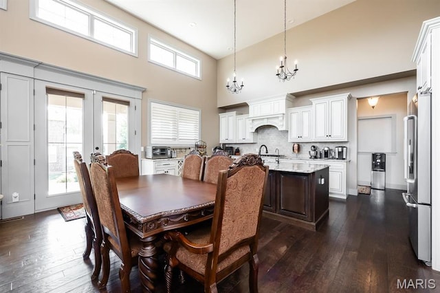 7032 Koufax Ct, Edwardsville, IL 62025 - dining space featuring a high ceiling, a chandelier, dark wood-type flooring, and french doors