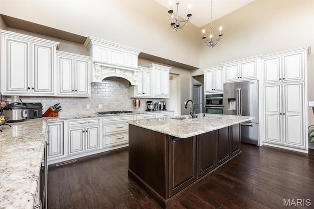 7032 Koufax Ct, Edwardsville, IL 62025 - kitchen featuring appliances with stainless steel finishes, dark wood-style floors, a sink, backsplash, and high vaulted ceiling