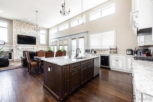 7032 Koufax Ct, Edwardsville, IL 62025 - kitchen featuring beverage cooler, open floor plan, dark brown cabinetry, dark wood finished floors, and a sink