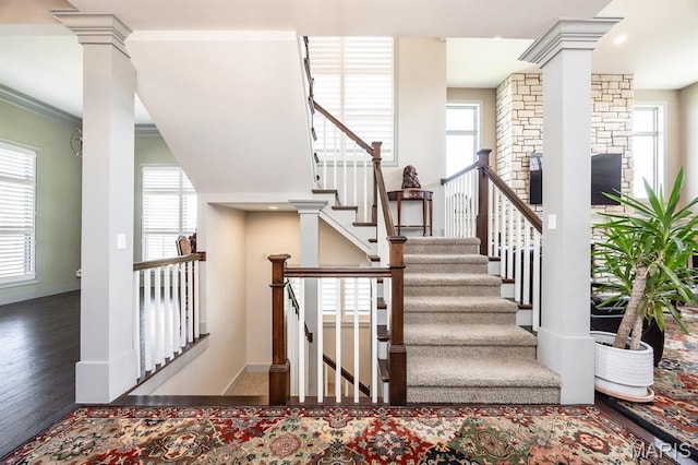 7032 Koufax Ct, Edwardsville, IL 62025 - stairs featuring decorative columns, plenty of natural light, wood finished floors, and ornamental molding