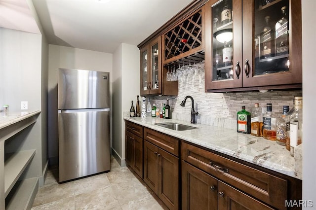 7032 Koufax Ct, Edwardsville, IL 62025 - indoor wet bar with freestanding refrigerator, decorative backsplash, and baseboards