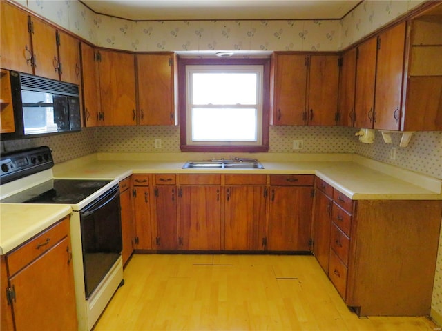 8 Indian Hills Dr, Cuba, MO 65453 - kitchen featuring white electric range oven, black microwave, a sink, light wood-style flooring, and wallpapered walls