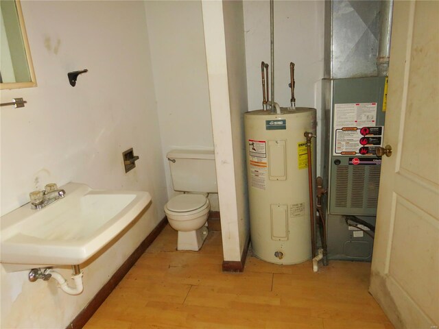 8 Indian Hills Dr, Cuba, MO 65453 - half bath with water heater, wood finished floors, toilet, and a sink