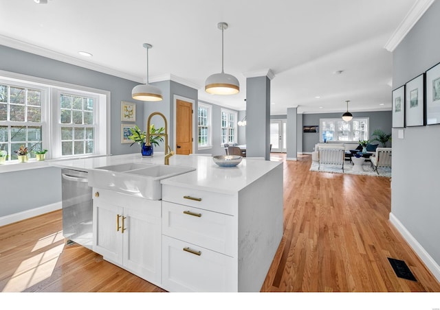 7825 Lafon Pl, Saint Louis, MO 63130 - kitchen with dishwasher, a sink, ornamental molding, white cabinets, and light wood-style floors