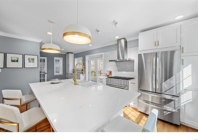 7825 Lafon Pl, Saint Louis, MO 63130 - kitchen featuring stainless steel appliances, wall chimney exhaust hood, a sink, ornamental molding, and white cabinetry