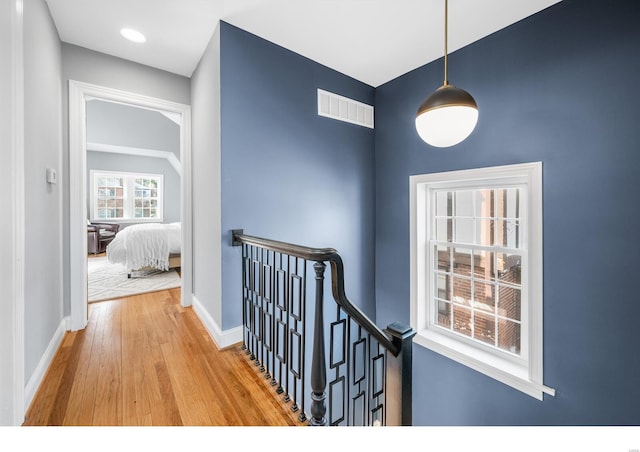 7825 Lafon Pl, Saint Louis, MO 63130 - hall featuring an upstairs landing, wood finished floors, and baseboards