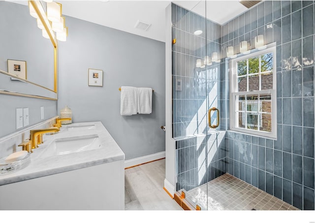 7825 Lafon Pl, Saint Louis, MO 63130 - bathroom featuring a shower stall, double vanity, and baseboards