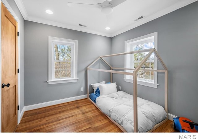 7825 Lafon Pl, Saint Louis, MO 63130 - bedroom with multiple windows, crown molding, wood finished floors, baseboards, and recessed lighting
