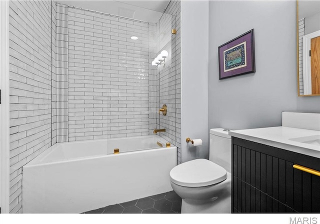 7825 Lafon Pl, Saint Louis, MO 63130 - full bath featuring toilet, tile patterned floors, vanity, and  shower combination