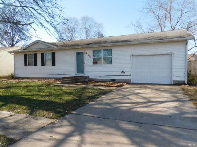 ranch-style home featuring concrete driveway, a front yard, and an attached garage