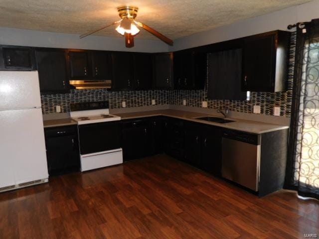 kitchen with freestanding refrigerator, range with electric cooktop, dishwasher, under cabinet range hood, and dark cabinets