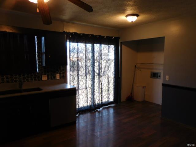living room featuring a ceiling fan, wood finished floors, and a textured ceiling